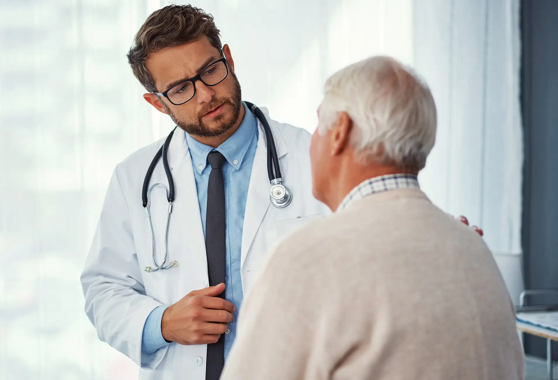 Doctor consulting with elderly male patient.